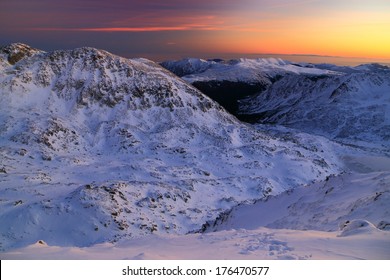 Snowy Mountains Under Orange Sunset Sky