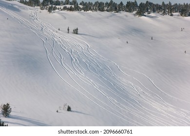 Snowy off-piste ski slope with traces of skis and snowboards on a sunny winter day in Sheregesh - Shutterstock ID 2096660761