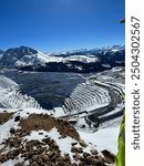 Snowy open pit mine in mountains