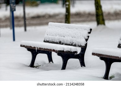 Snowy Park Bench With Light Snowfall