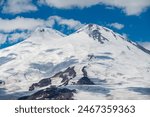 Snowy peak of Mount Elbrus in spring. Caucasus mountains. Kabardino-Balkaria Reublic. Panorama of Elbrus. Stunning view of the highest mountain in Europe