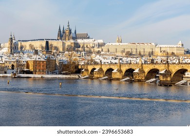 Snowy Prague Lesser Town with Prague Castle and Charles Bridge above River Vltava in the sunny Day , Czech republic