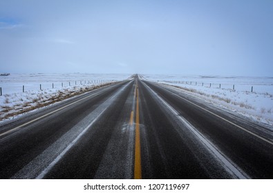 Snowy Road In The Prairies In The Middle Of Nowhere.