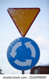 Snowy Road Sign, Intersection With Circular Traffic.