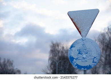 Snowy Road Sign, Intersection With Circular Traffic.