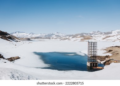 Snowy scenery in Chilean Andean frozen lake. Wintery landscape