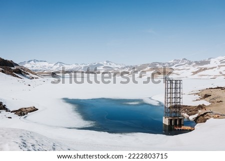 Snowy scenery in Chilean Andean frozen lake. Wintery landscape