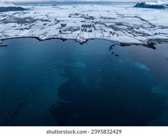 Snowy Shoreline Contrast Along Norway's Blue Sea - Powered by Shutterstock