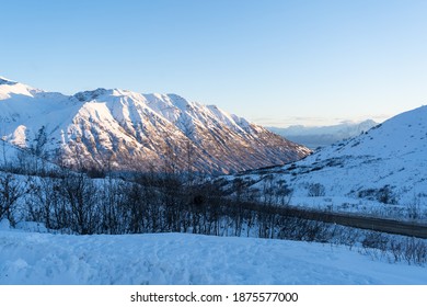 Snowy Side Of A Mountian During Sunset