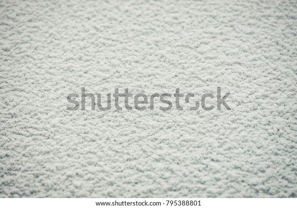 Snowy solid texture. Background detailed snow\
image on a flat surface.