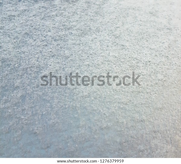 Snowy texture on the hood of\
a car