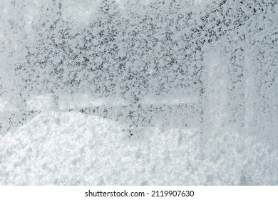 A Snowy Window During A Heavy Blizzard. View From The Indoor, Covered Glass On The Outside. Background Throughout A Garden.