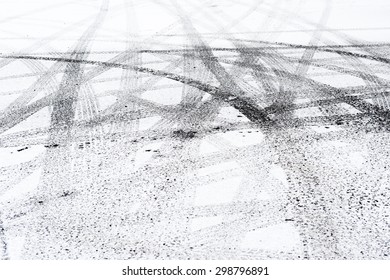 Snowy winter city road with tire trace.