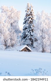 Snowy Winter Landscape Of Lapland. Wooden, Village Houses Covered With Thick Snow.