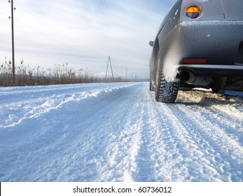 Snowy Winter Road Behind An Unrecognizable Car