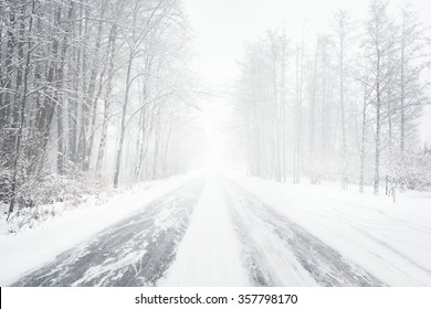 Snowy winter road during blizzard in Latvia. Heavy snow storm. - Shutterstock ID 357798170