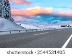 Snowy winter road landscape in beautiful nature travel. Winter sunset in mountain road scenery. Winter landscape on the highway in snowy mountains. nature trip in snow. highway view on christmas time.