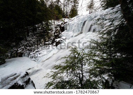 A snowy, winter scene at the remote Shelving Rock Falls deep within the Lake George Wild Forest in the Adirondack Mountains of New York.