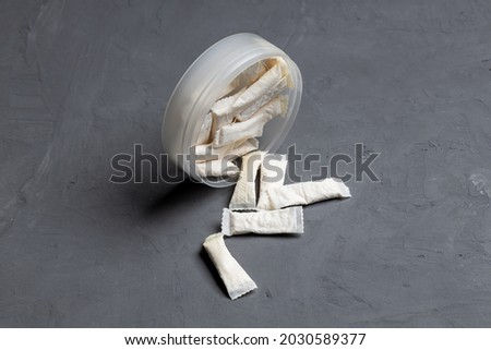 snus nicotine pouch product on concrete background. outer space. chewing nicotine bags. danger unhealthy addiction.