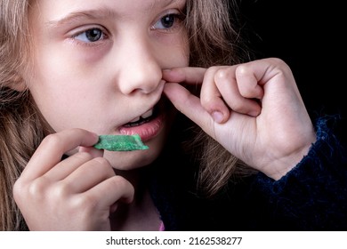 snus. tobacco in bags. a female child uses nicotine. close-up.