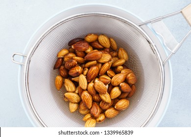 Soaked Almonds In A Strainer. Ingredients For Making Nut Milk. Step By Step Recipe.