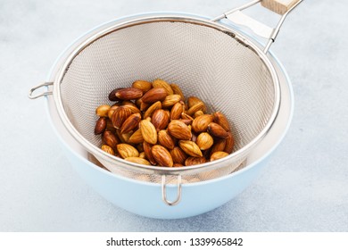 Soaked Almonds In A Strainer. Ingredients For Making Nut Milk. Step By Step Recipe.