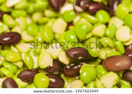 Soaked and swollen dark beans and green peas for cooking a vegetarian dish. Macro, selective focus.