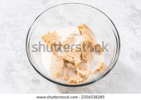 Soaking stale bread in milk to make meatloaf.