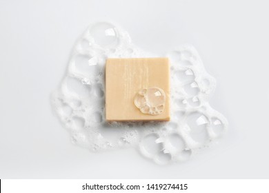 Soap Bar And Foam On White Background, Top View. Mockup For Design