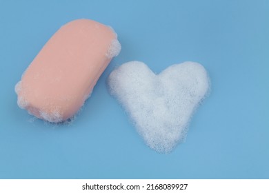 Soap bar and heart shaped foam bubbles  on blue background. Softness and romance concept. - Powered by Shutterstock