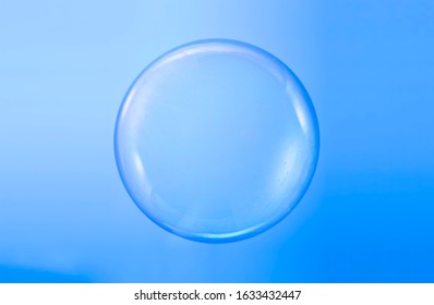 Soap bubble ball water drop foam bubbles. Isolated on blue background