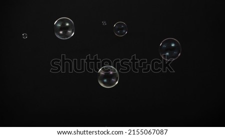 Soap bubble drop or Shampoo bubbles floating like flying in the air black background which represent refreshing moments and gentle soft. Bubbles drops for soap  shampoo or detergent product industry.