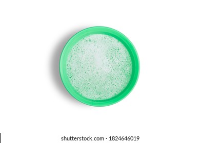 Soap Bubbles In The Green Plastic Bowl Isolated On White Background.The Concept Is To Prepare Soapy Water For Hand Washing.