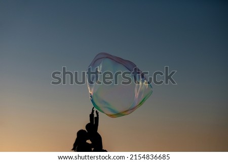 Soap bubbles. Hands trying to catch floating soap bubbles. Bubble show, buble party.
