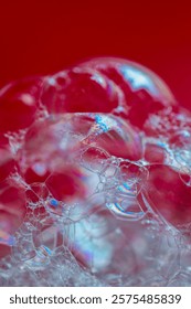 Soap bubbles in macro shoot on red background