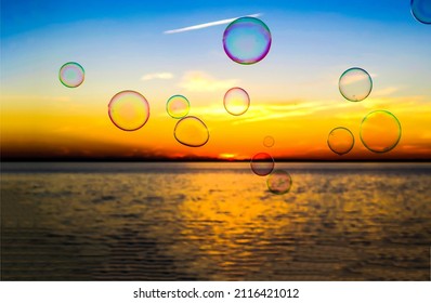 Soap bubbles on the background of dawn. Sunrise soap bubbles. Soap bubbles at sunrise. Soap bubbles at dawn background