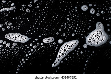 Soap Bubbles On Black Surface