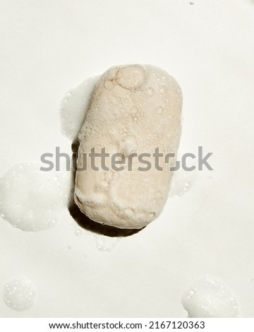
soap with soap bubbles on white background. top view. hard light
