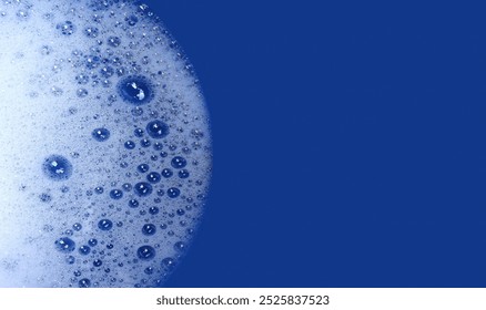 Soap foam of bubbles textures border on blue background with copy space for wash design concept top view