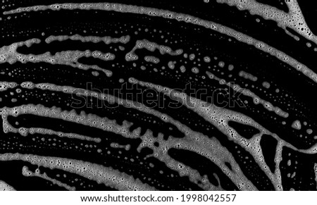 Soap foam, lather bubbles isolated on black background and texture with clipping path, top view