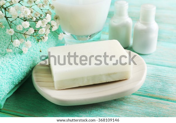 Soap on a dish\
over wooden background, close\
up