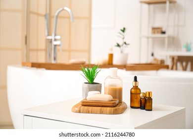 Soap, plant and cosmetic products on table in bathroom - Shutterstock ID 2116244780