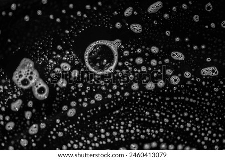Soap suds create a bubbly texture on the plate. Detergent helps remove grease and dirt from dishes. The cleaning agents in soap break down dirt and oil on the surface.