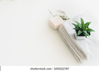 Soap And White Cotton Towels On White Counter Table Inside A Bright Bathroom Background.  For Product Display Montage.