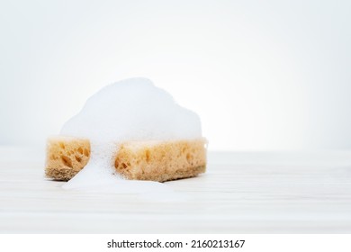 Soapy Sponge On White Bathroom Tiles.