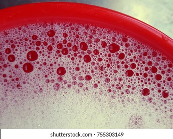 Soapy Water In Red Bucket.