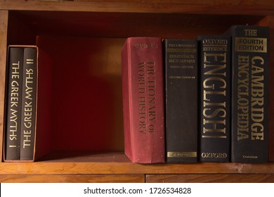Sobral, Ceará/Brazil - May 9, 2020: Book shelf with some old and used encyclopedias and dictionaries. Books about greek mythology in the left.