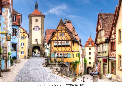 The so-called "Plönlein", a fork in the road framed by old, historic houses and watchtowers or gate towers in the historic old town of Rothenburg ob der Tauber, Franconia - Shutterstock ID 2204848101