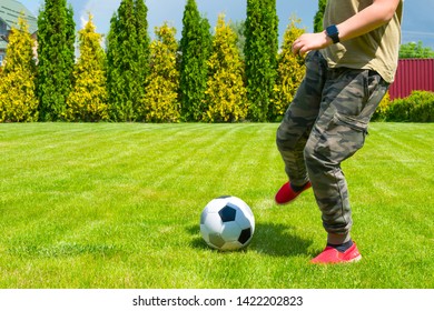 Soccer ball and boy's legs close up. The teenager plays soccer on the backyard. - Powered by Shutterstock