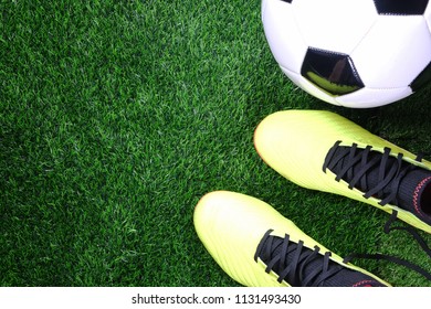 Soccer Ball And Football Boots On Green Grass